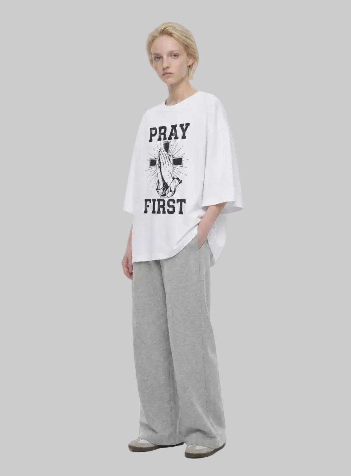 Pray First white T-shirt by Kingdom Mind Apparel featuring a simple prayer-themed design on the front.