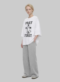 Pray First white T-shirt by Kingdom Mind Apparel featuring a simple prayer-themed design on the front.