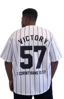 Male model wearing the black Victory Jersey by Kingdom Mind Apparel, showing the back design with bold lettering.