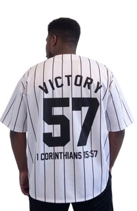 Male model wearing the black Victory Jersey by Kingdom Mind Apparel, showing the back design with bold lettering.