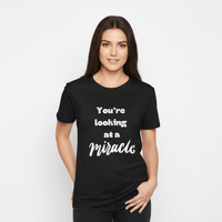 Female model in black miracle shirt