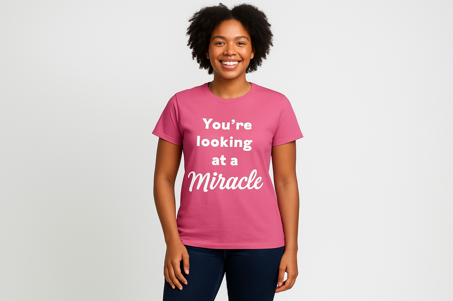 Full body female model wearing bright pink miracle shirt