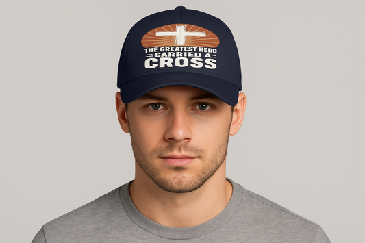 professional-model-wearing-the-navy-blue-baseball-cap-with-the-greatest-hero-carried-a-cross-text-and-cross-design-with-radiating-sunburst-background.png